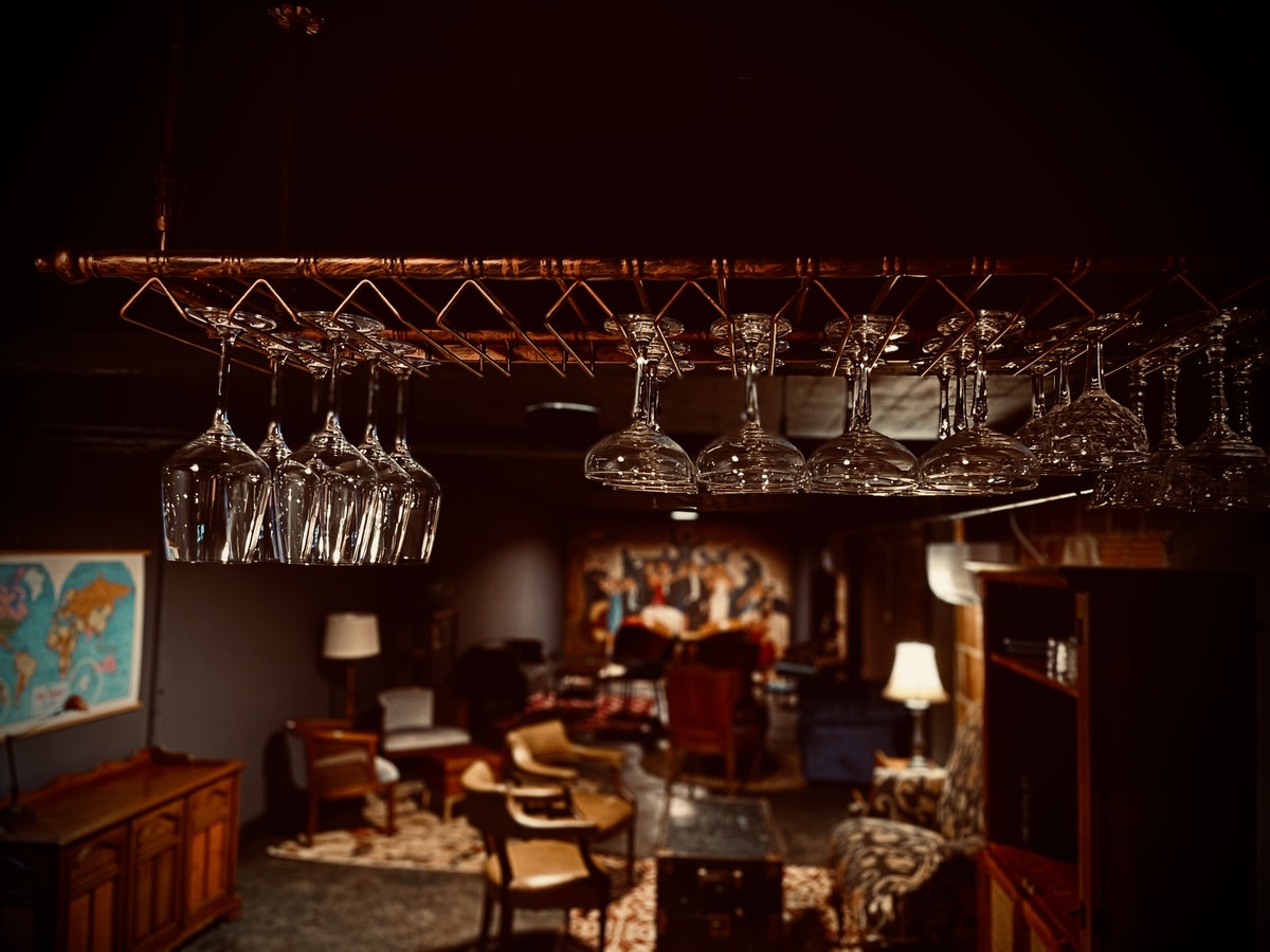 A room with wine glasses hanging from the ceiling