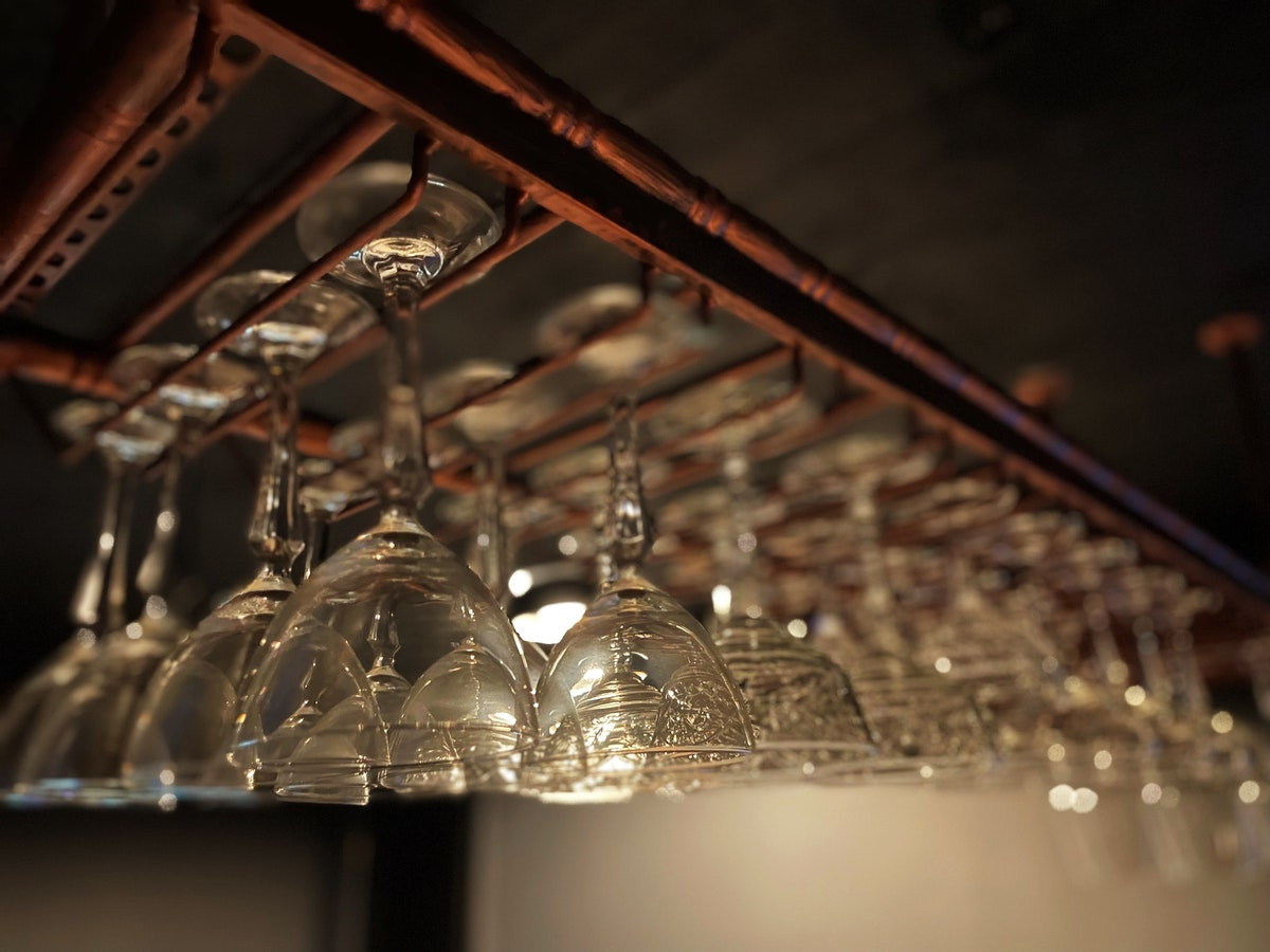 A rack of wine glasses hanging from the ceiling