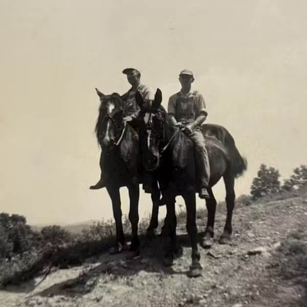 Two men riding horses