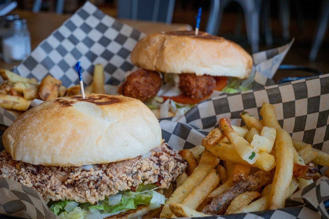 A chicken sandwich and crispy french fries are placed on a table, ready to be savored.