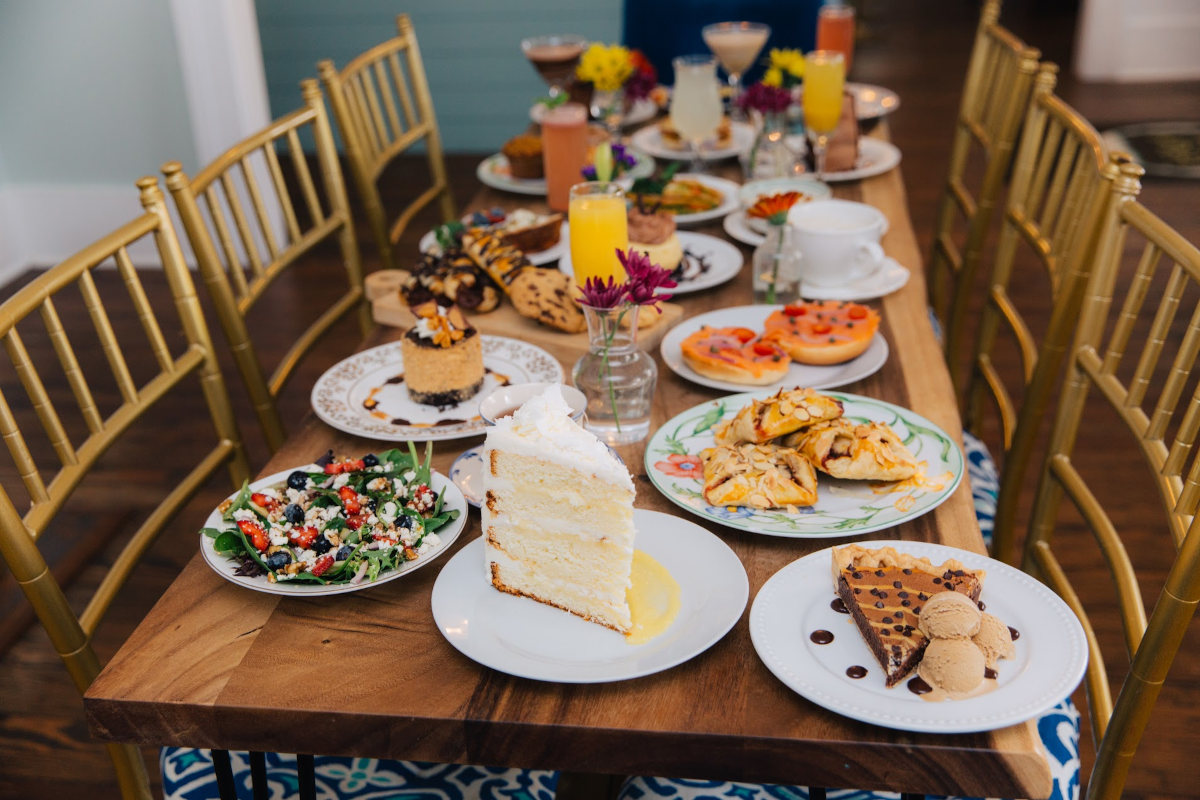 A table set with various plates of food and drinks