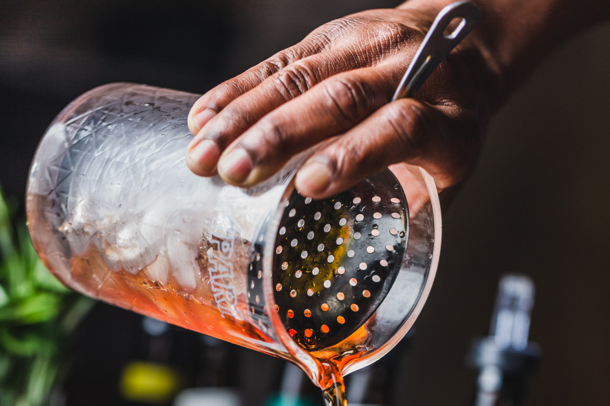 Staff member making Manhattan cocktail