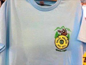 White T-Shirt with a 'Bagel Mainea' logo