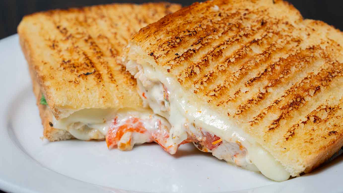 Chicken tomato mozzarella panini with black coffee