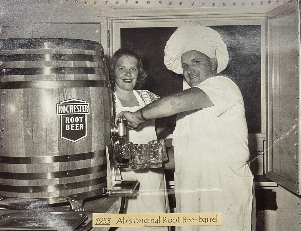 Two persons pouring beer from a barrel