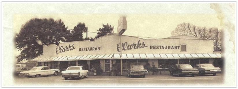 An old photo of a restaurant with cars in front of it.