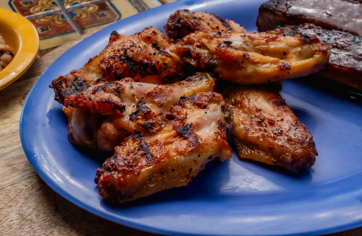 Front view of a plate of grilled chicken wings