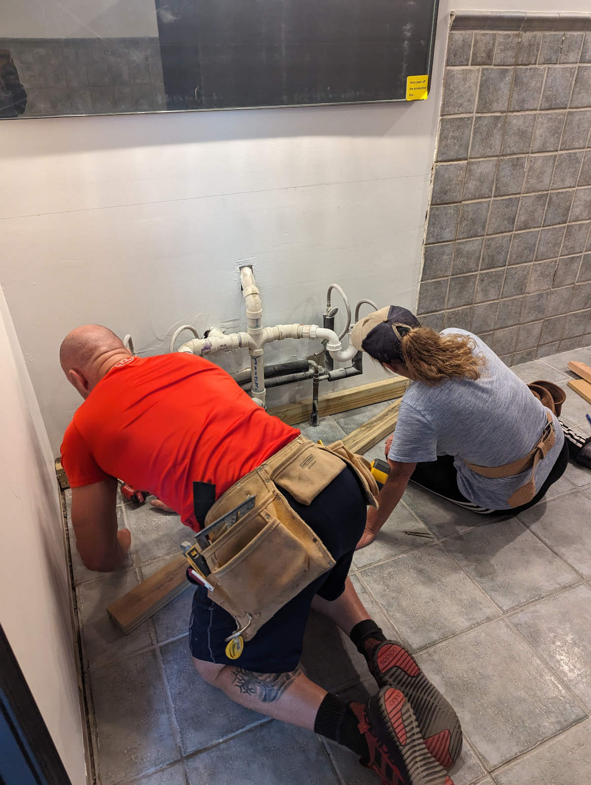 Plumbers working on pipes