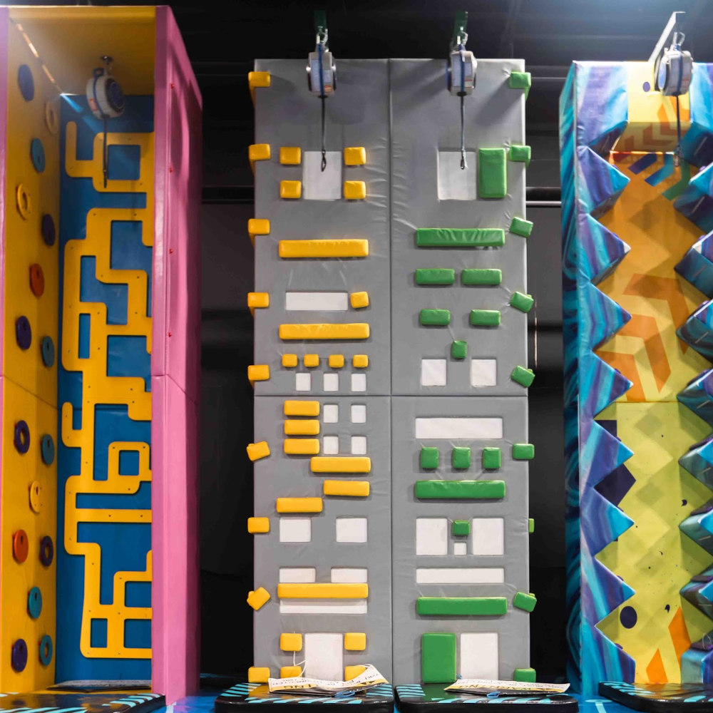 A group of colorful climbing walls in a store.