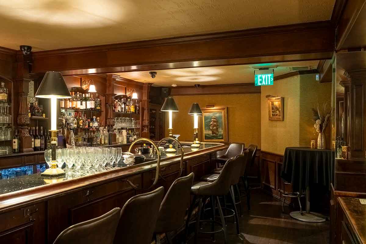 A classic, wood-paneled restaurant bar with leather chairs and an extensive liquor selection.