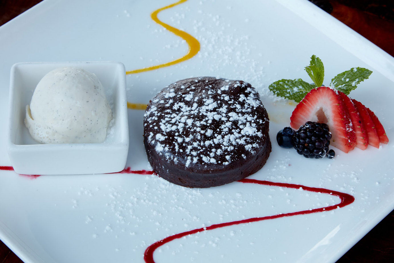 Chocolate yuzu cookie with berries and a scoop of ice cream