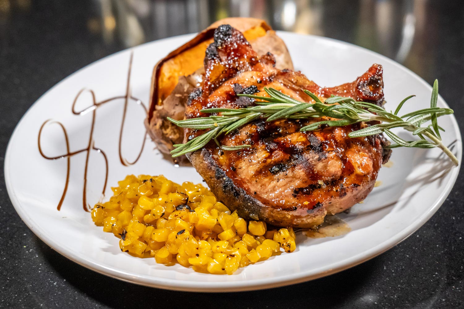 whiskey glazed porkchop roasted sweet potato and roasted corn