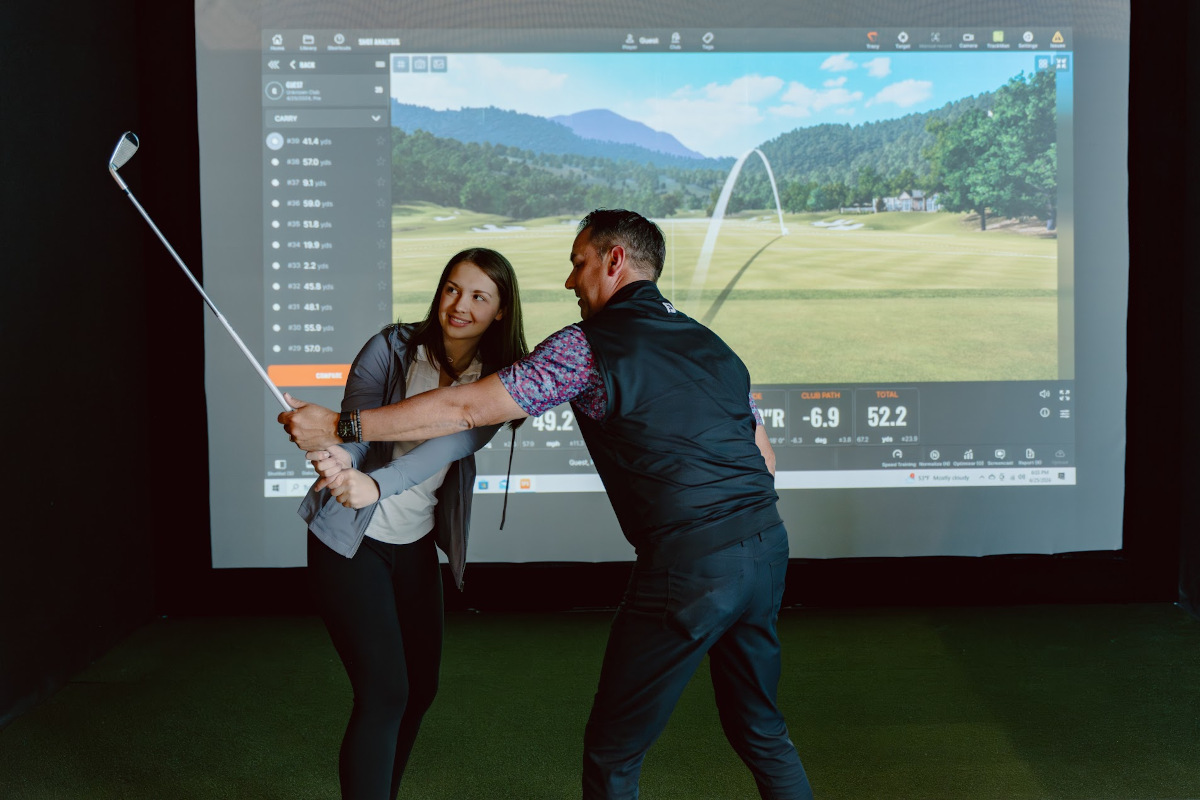 Golf instructor showing the player how to swing a golf club