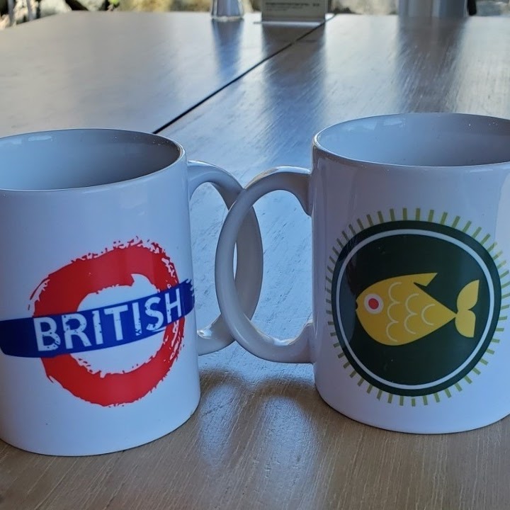 Two british mugs on a table.