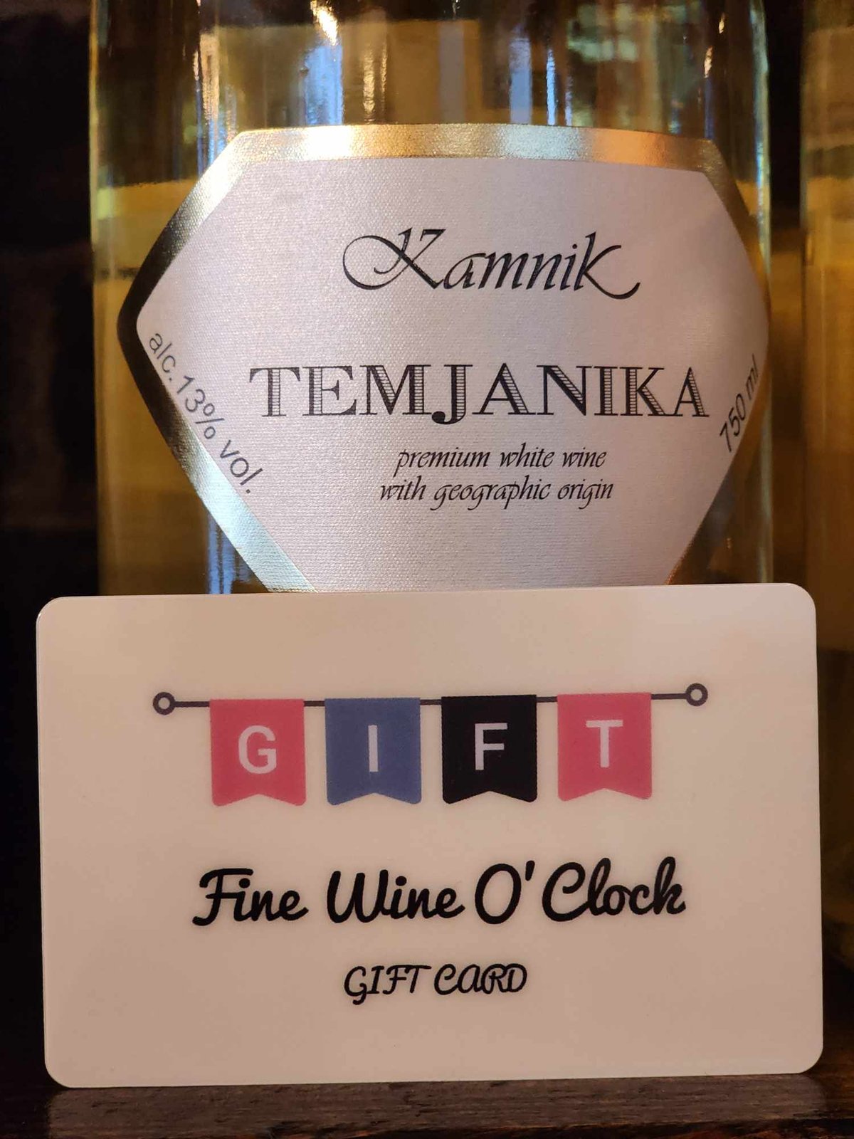 a bottle of wine with a gift card