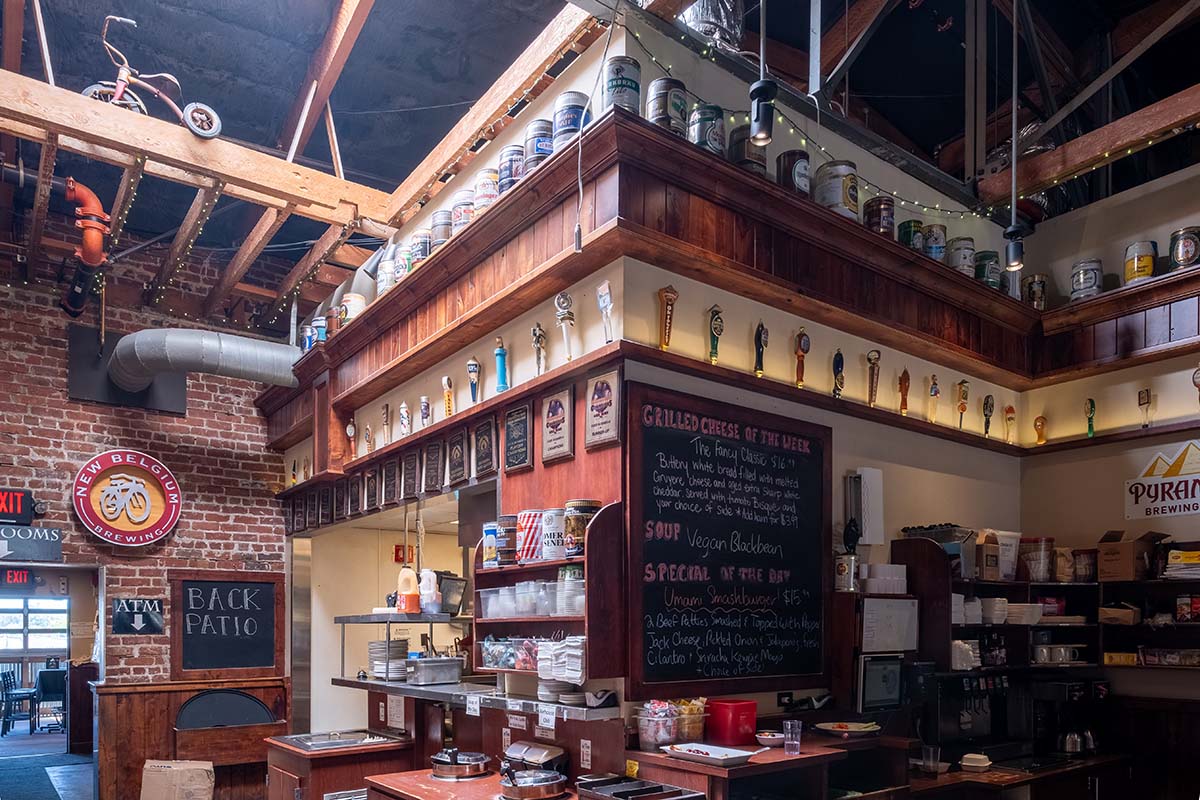 A rustic Alehouse with a brick ceiling and abundant shelves, creating a cozy ambiance