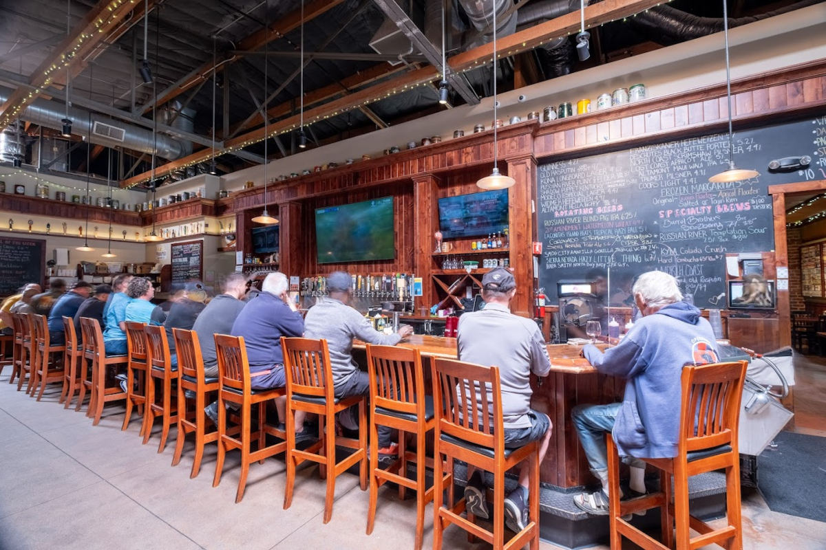 Customers seated at Alehouse bar, enjoying drinks