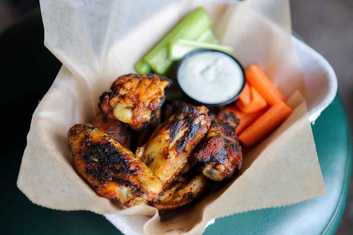 Grilled smoked chicken wings, with celery, carrots, and blue cheese dressing