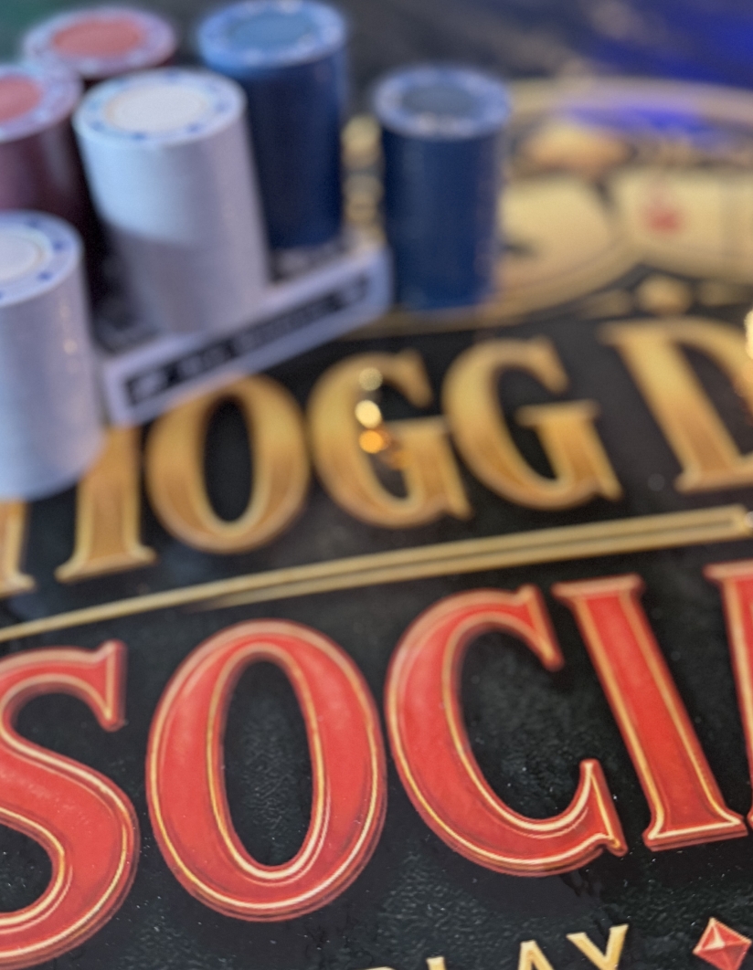Poker chips stacked beside the Hogg Daddy’s Social Club sign