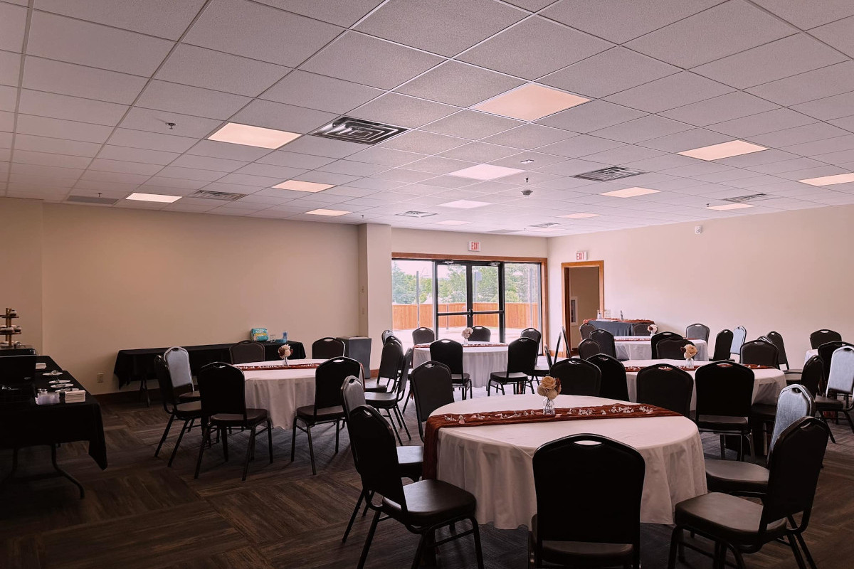 A beautifully decorated banquet room featuring elegant white and purple drapes