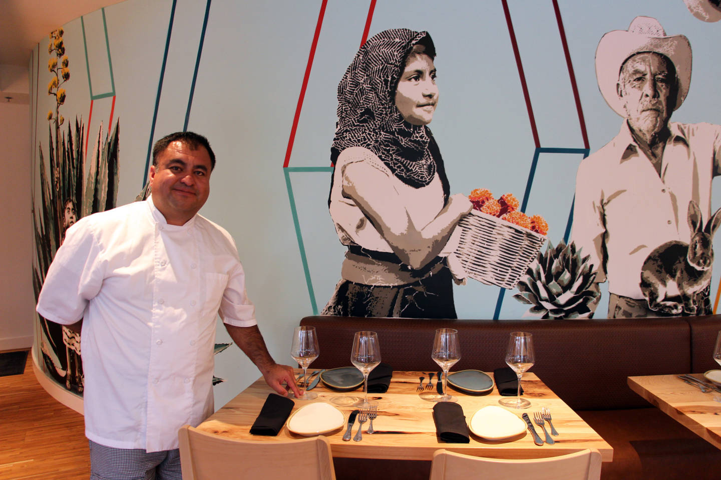 Chef Octavio Diaz in front of the mural at Agave Uptown (Wendy Goodfriend)