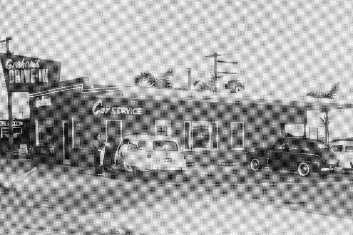 car service station, showcasing a vintage ambiance with classic vehicles and mechanics at work.