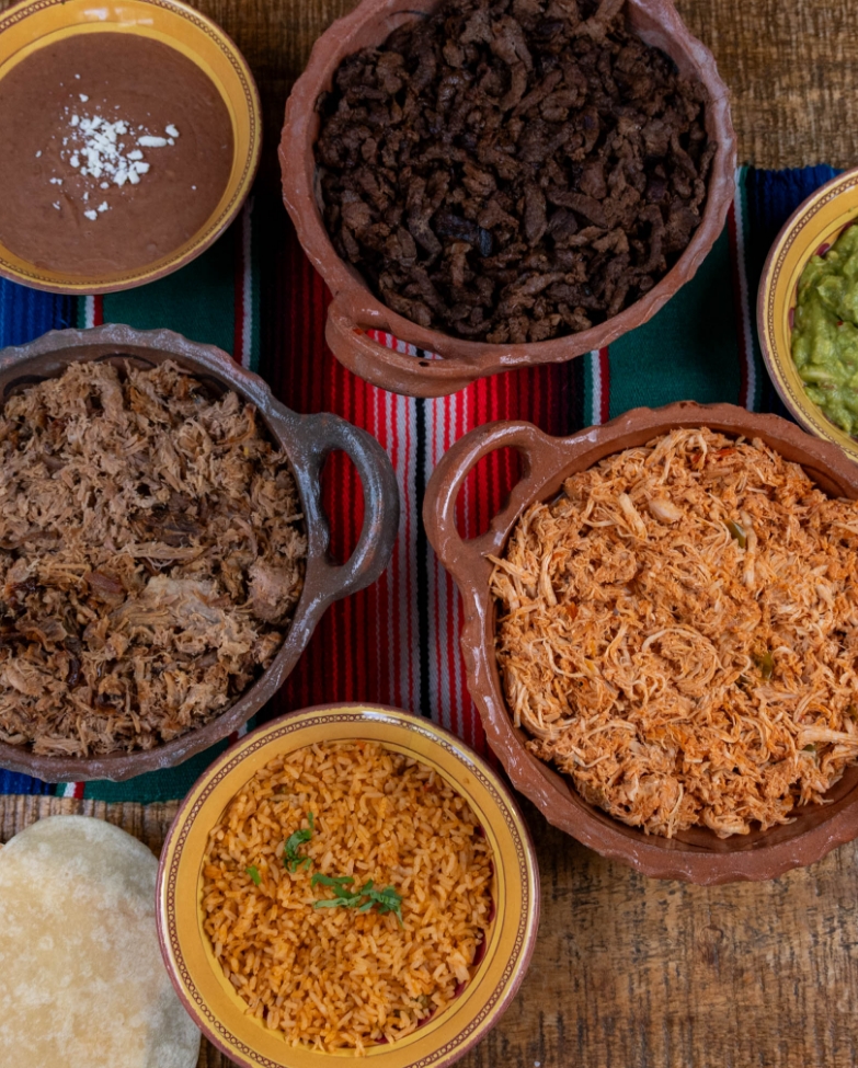 Build your own taco bar spread with meats, rice, beans and tortillas