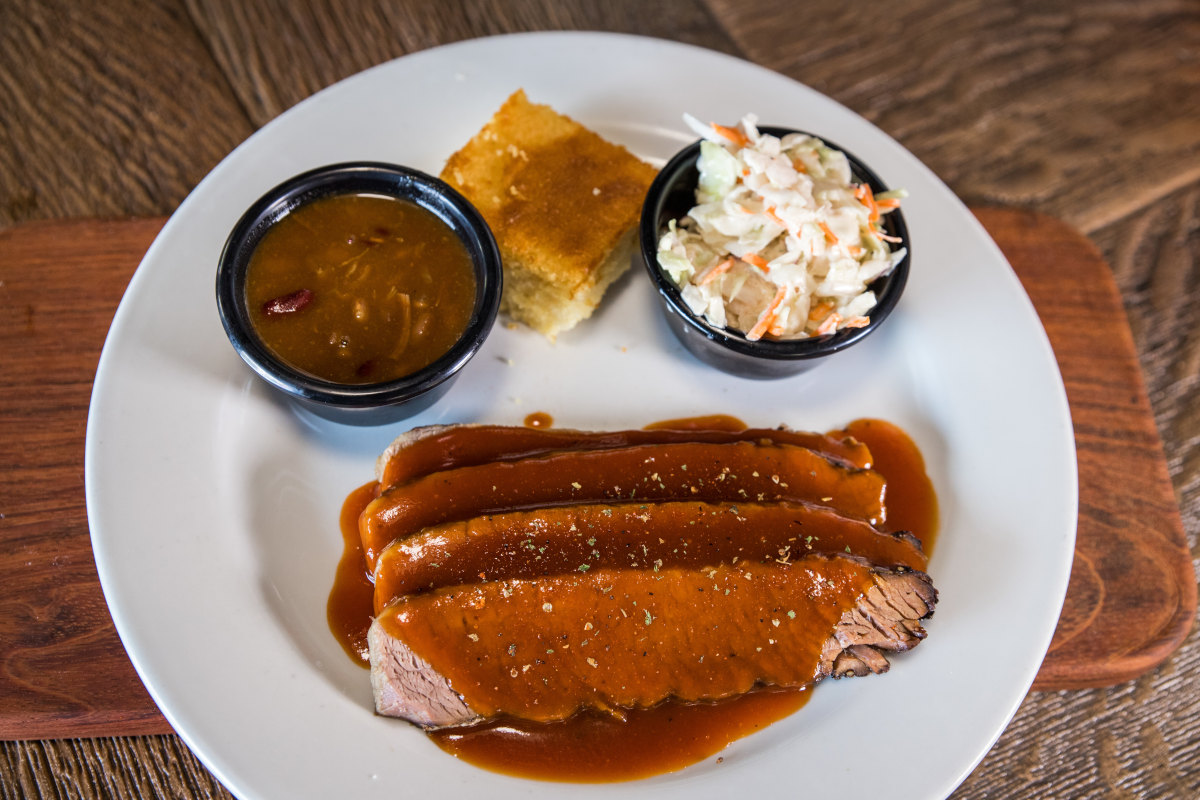 Meat covered with sauce served on a plate