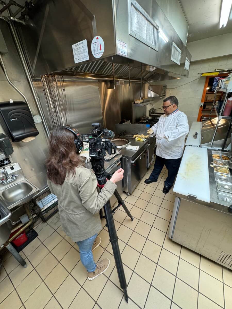 Chef Hemant Mathur with a camerawoman in the kitchen