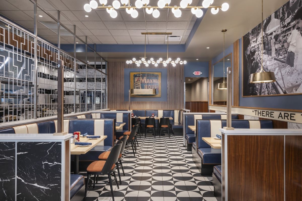 A modern restaurant interior featuring blue and cream-colored booth seating