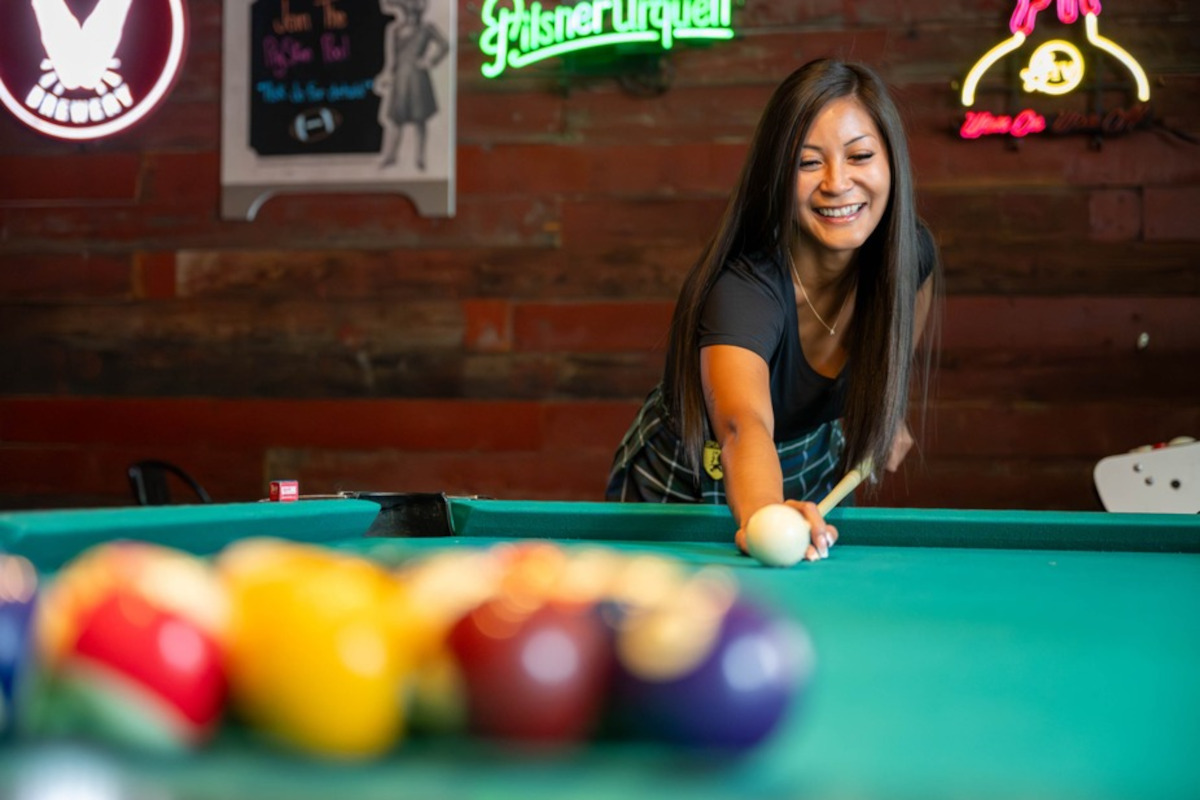 Woman taking a pool shot