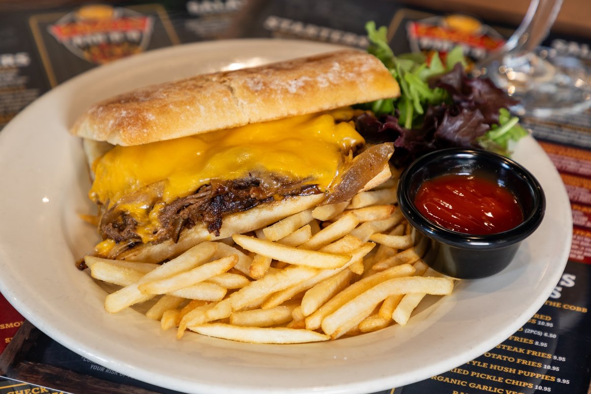 Sandwich with chopped meat and fries on the side