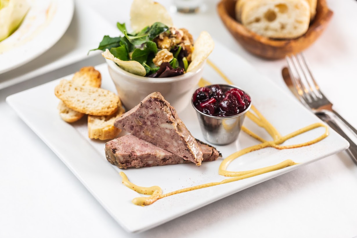 French country pate served with baguette, small salad and berry sauce
