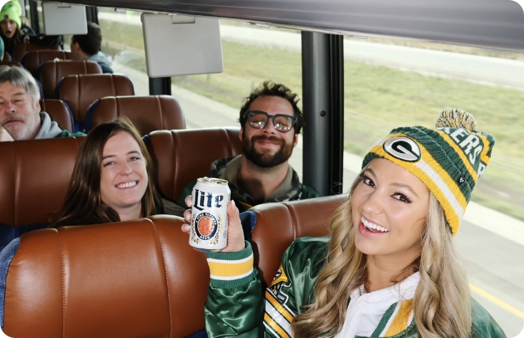 Fans with drinks on the Who's on Third Packers bus