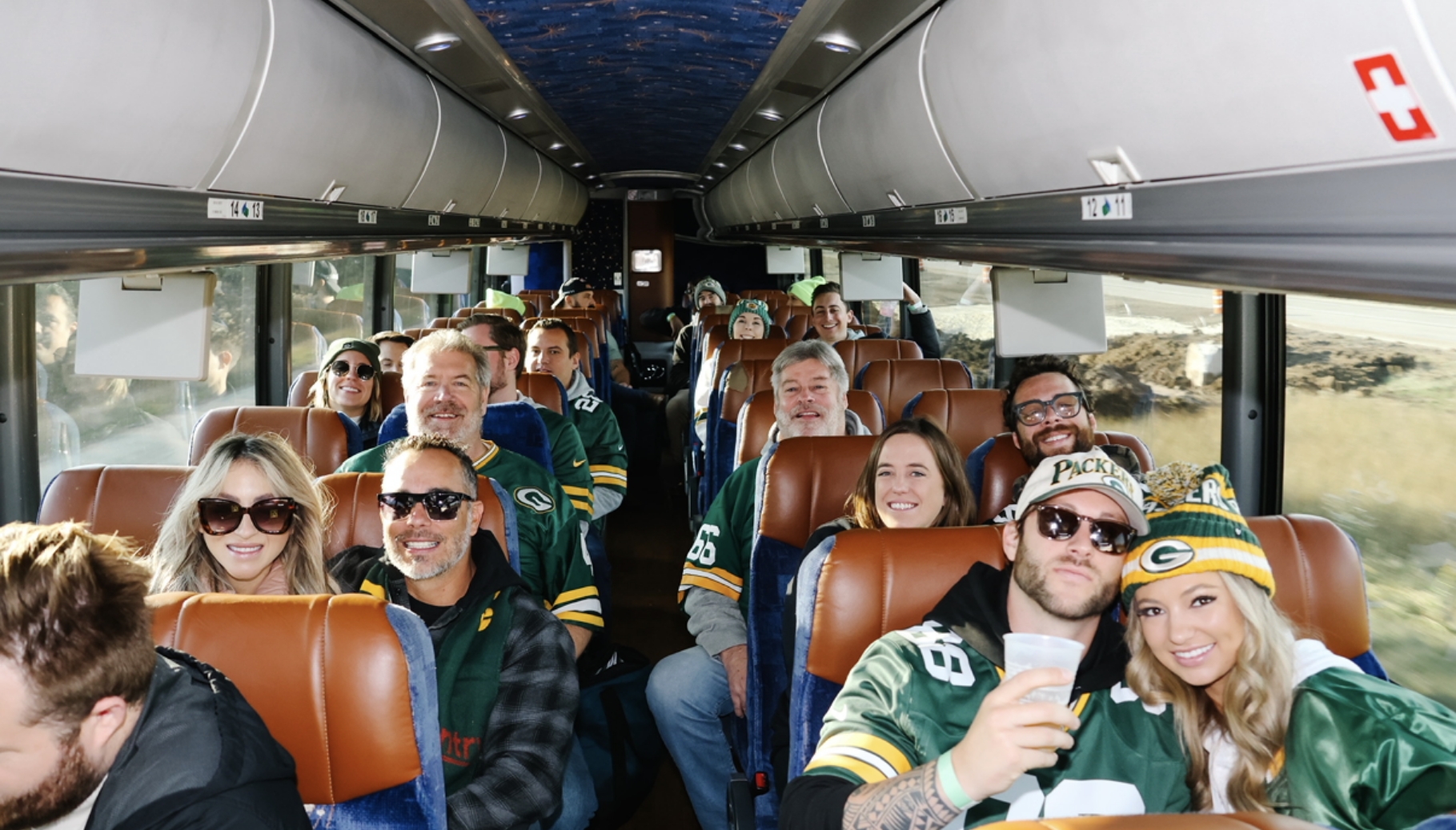 Fans riding the Who's on Third Packers bus shuttle