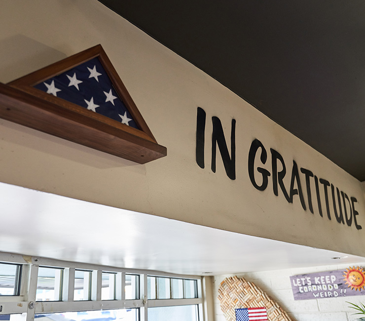 A sign that says in gratitude on the wall of a restaurant.