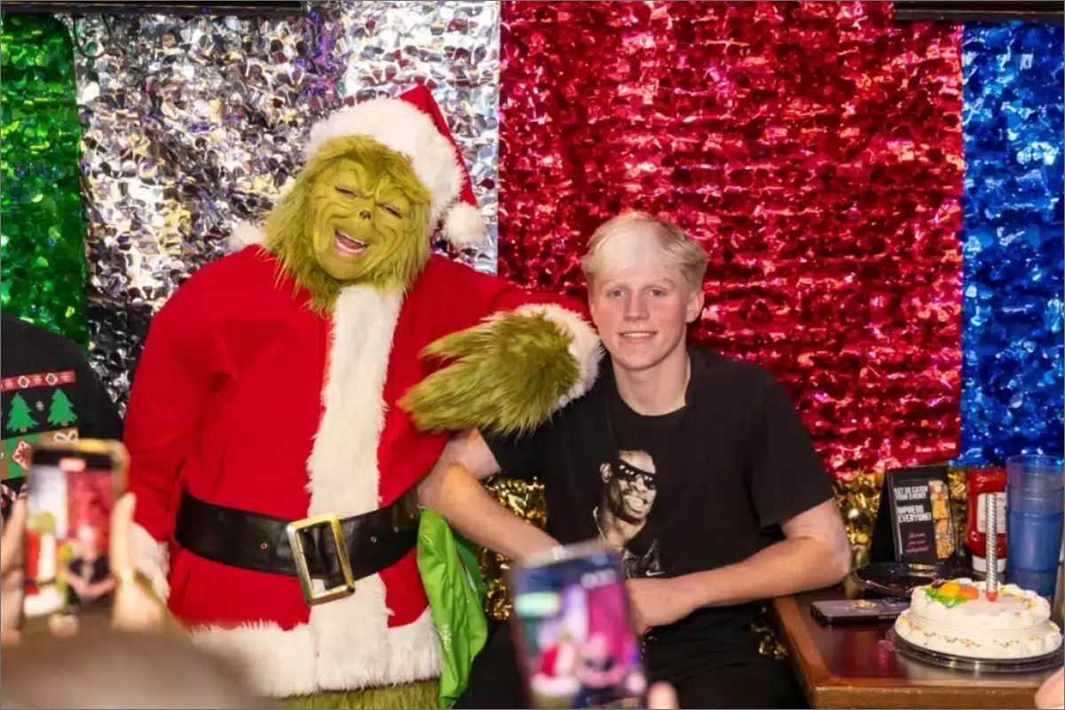 The Grinch posing with a guest