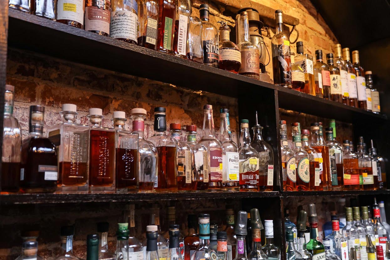 Bar shelves with various bottled spirits