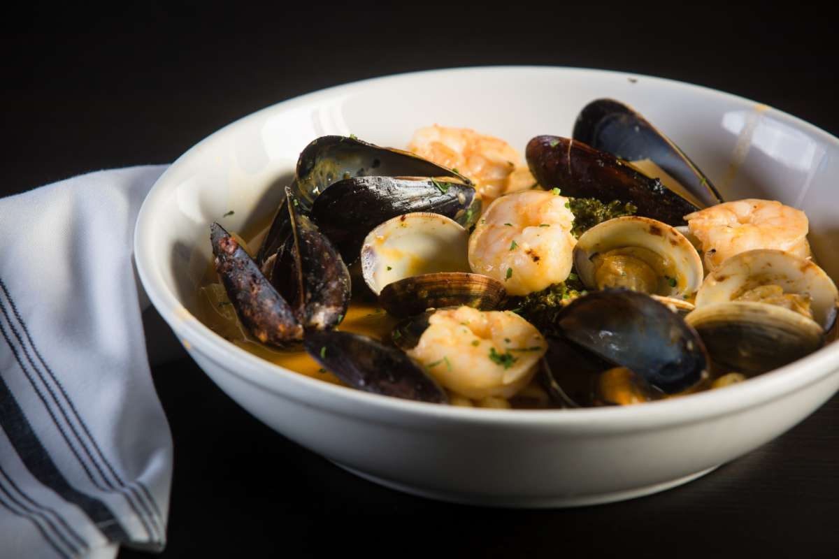 Dish of steamd mussels and clams in a sauce