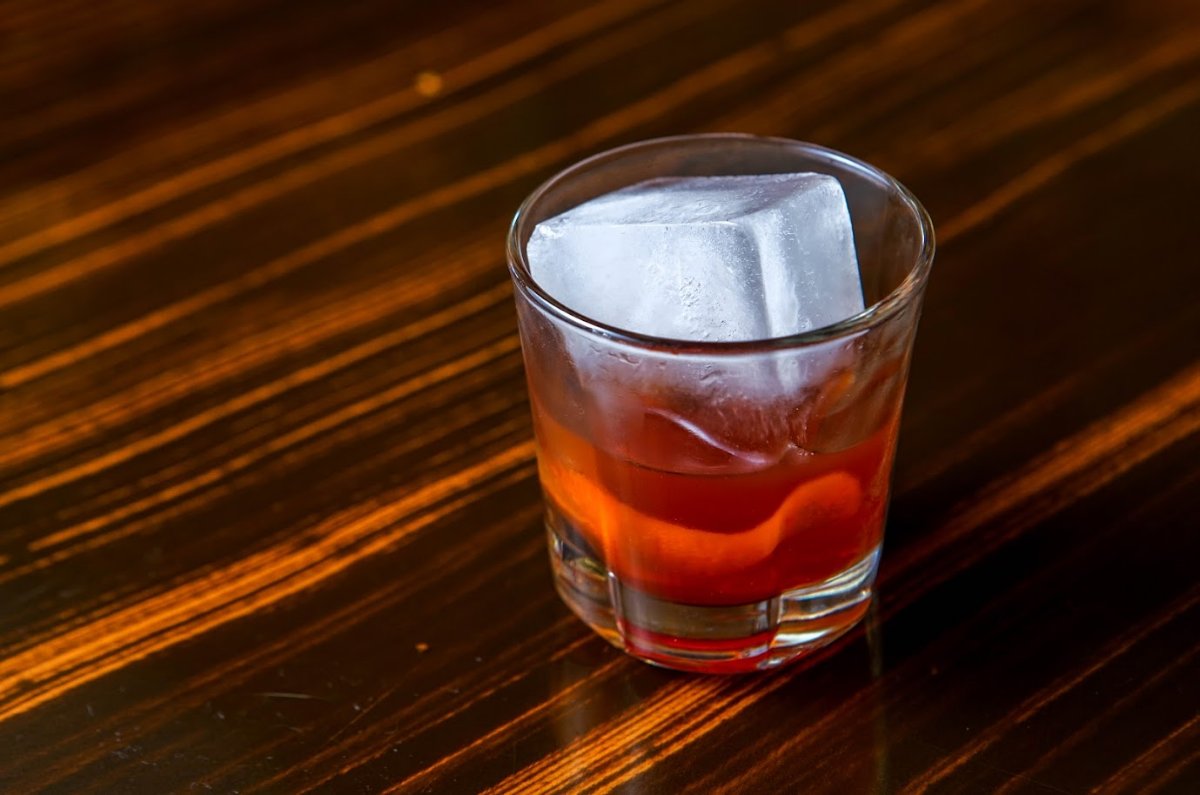 A glass of Manhattan cocktail served with ice