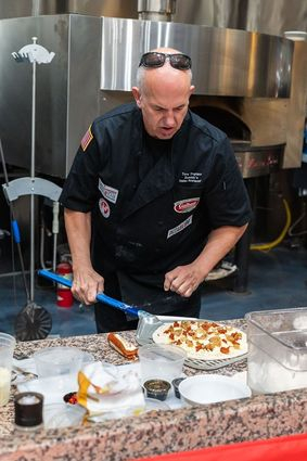 Tore Trupiano tops his five grain crust with mozzarella, nduja sausage and cipollini onions.