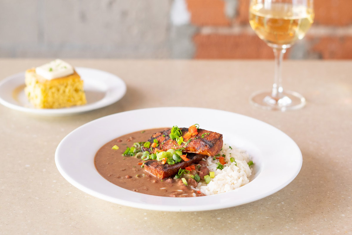 Andouille sausage red bean rice dish served with cornbread and white wine 