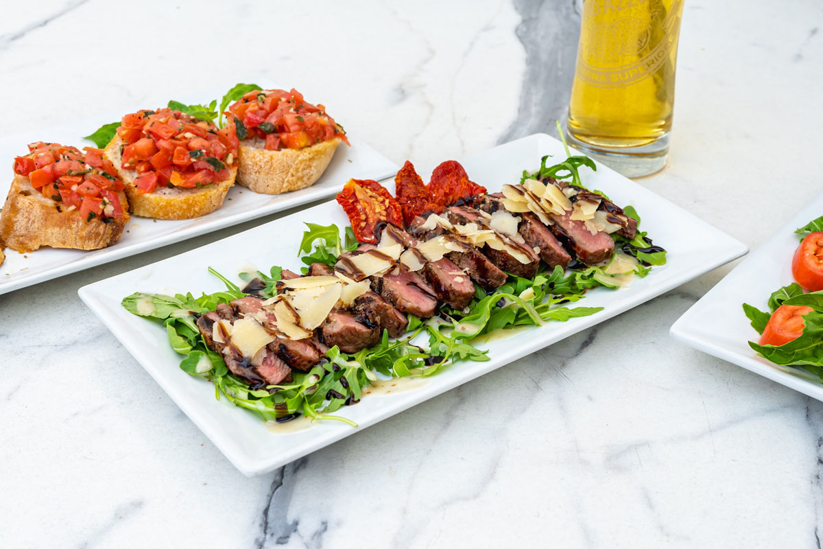 Branzino filets, with arugula and red peppers, and Bruschetta with pico de gallo