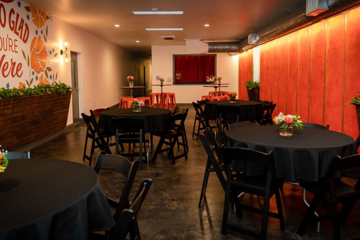 Round tables set up inside the private event space.