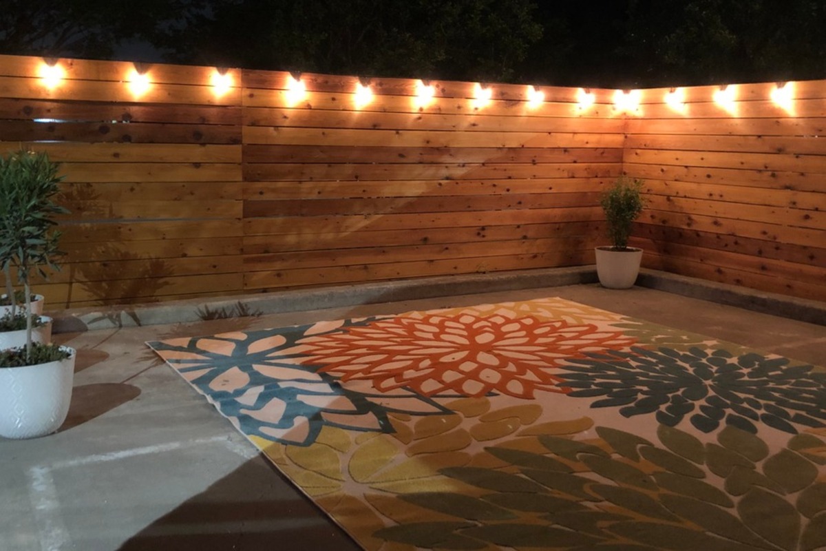 The private courtyard lit by string lights in the evening.