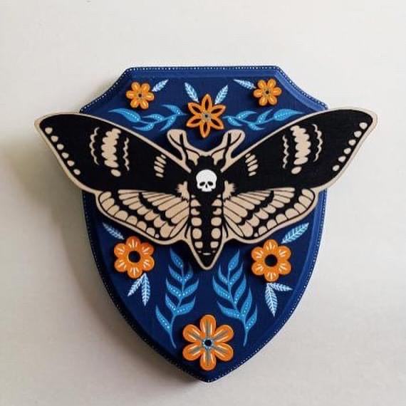 Butterfly on a blue shield