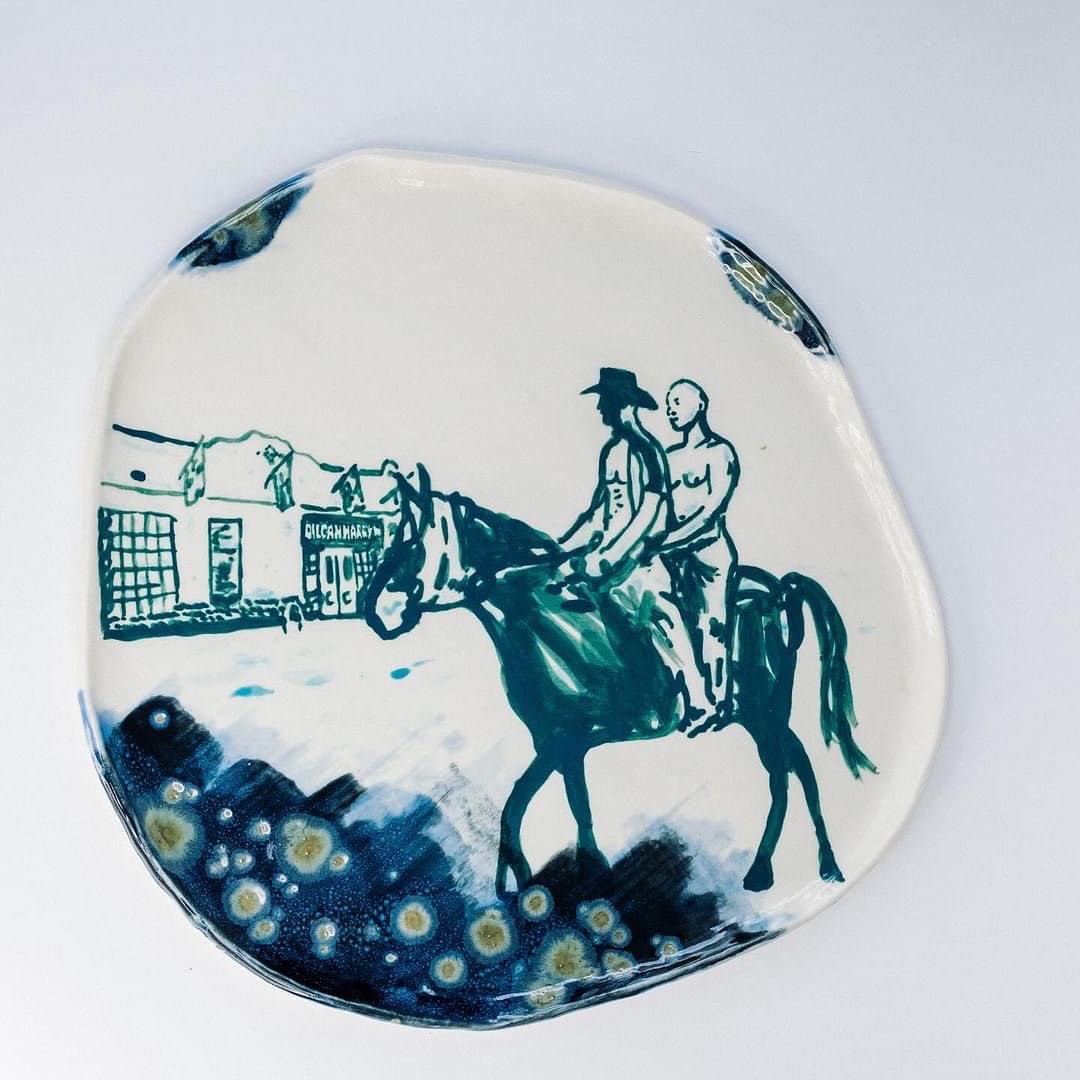 Plate with a picture of a person riding a horse