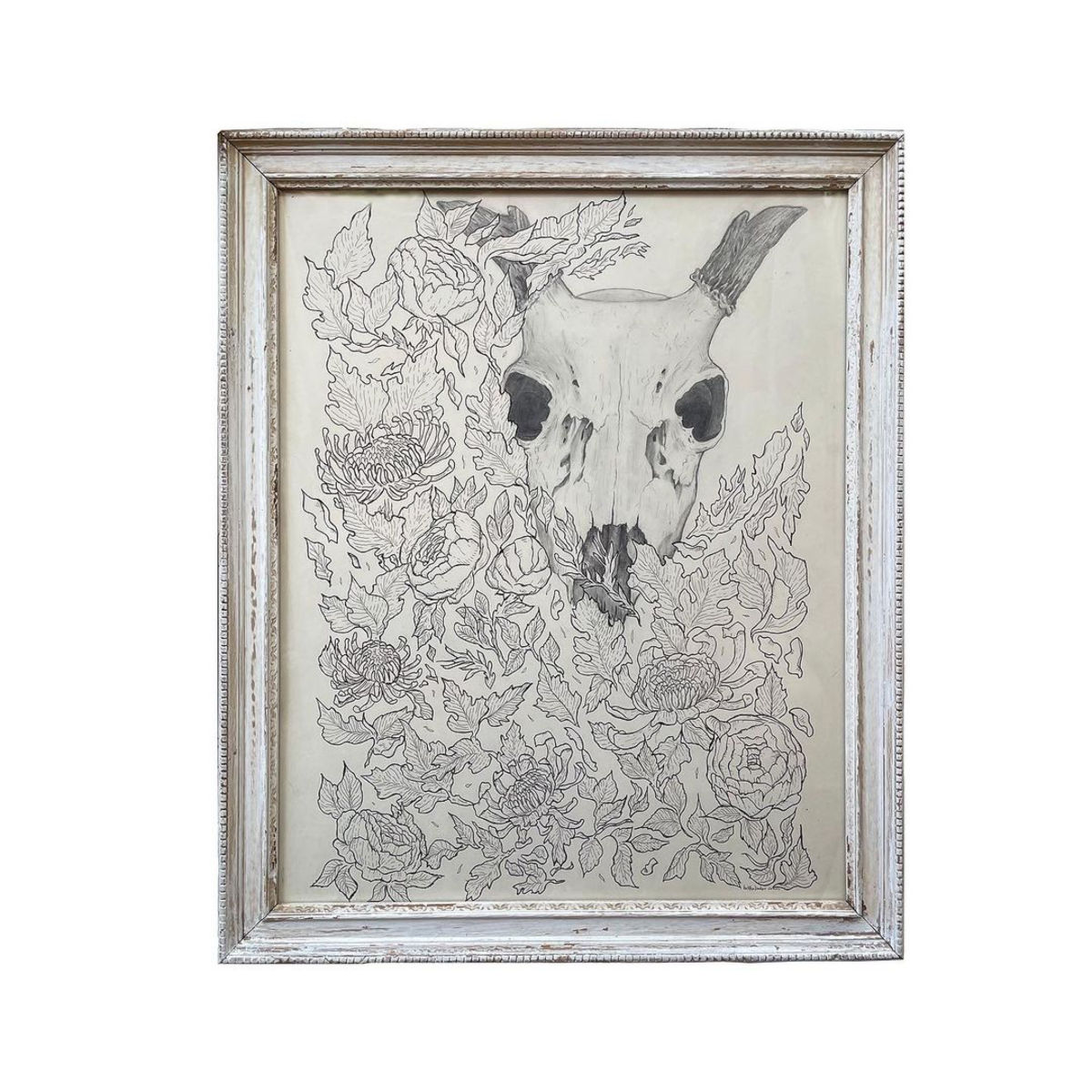 a framed picture of a skull and flowers