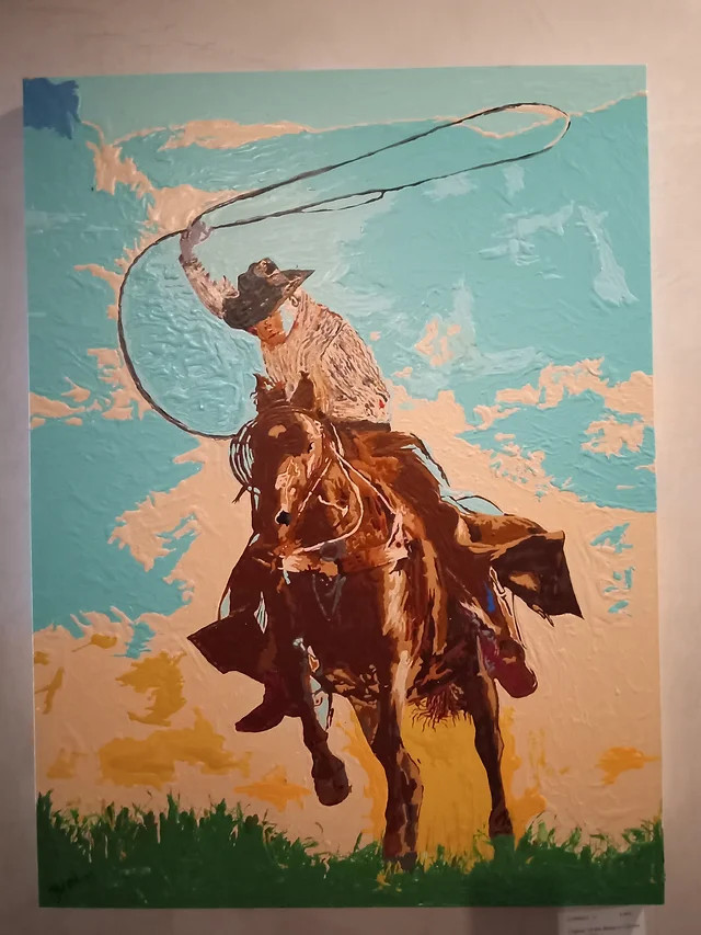 Painting of a cowboy on a horse