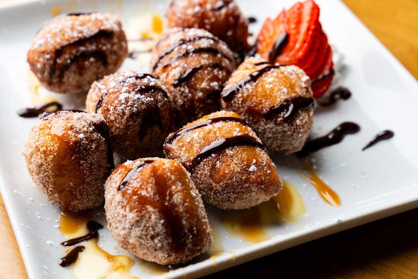 Mini donut balls, with chocolate drizzle and strawberry